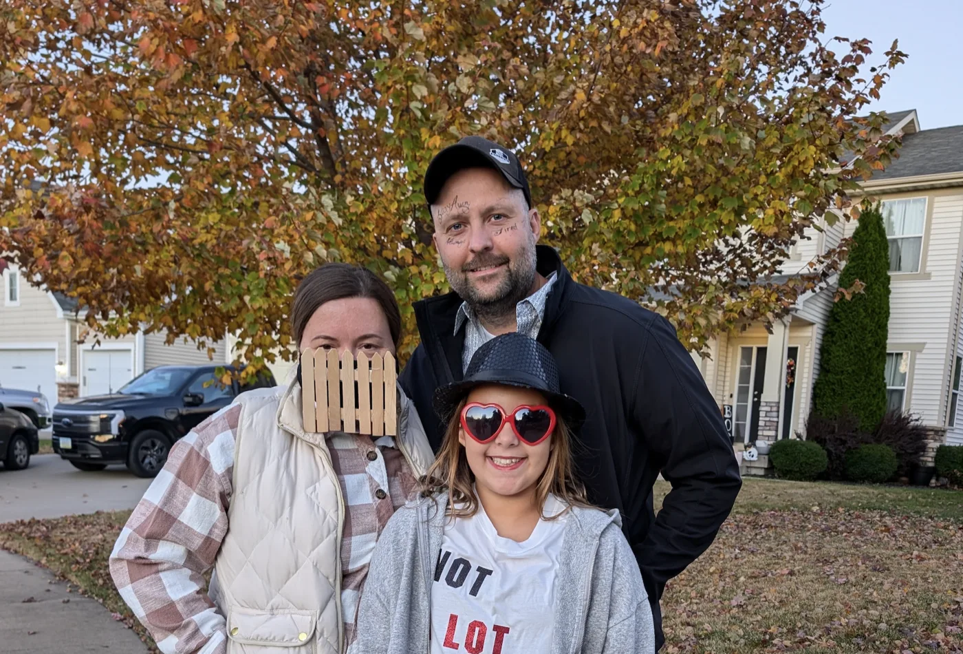 Me in a Post Malone Halloween costume with drawn-on face tattoos, out trick-or-treating with my family.